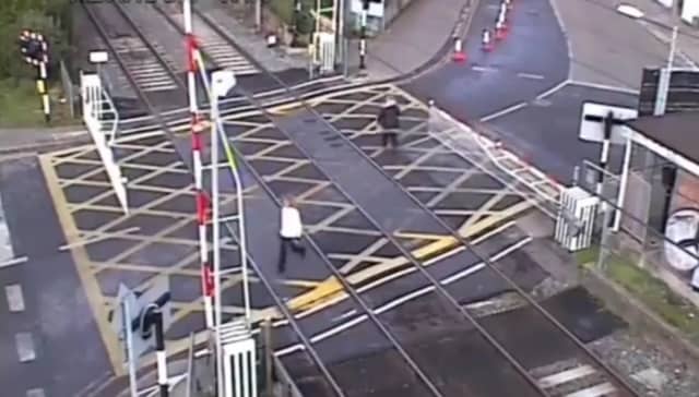 Woman crushed by level crossing barrier.