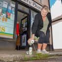 Shop worker Tracey Way, 61, pours Inch's Cider down the drain.